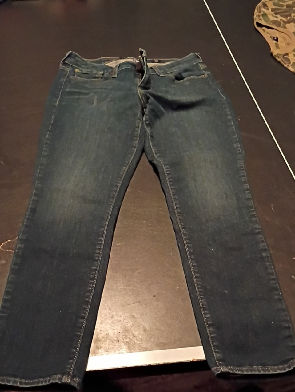 Lucky Brand dark blue denim jeans with tan leather patch